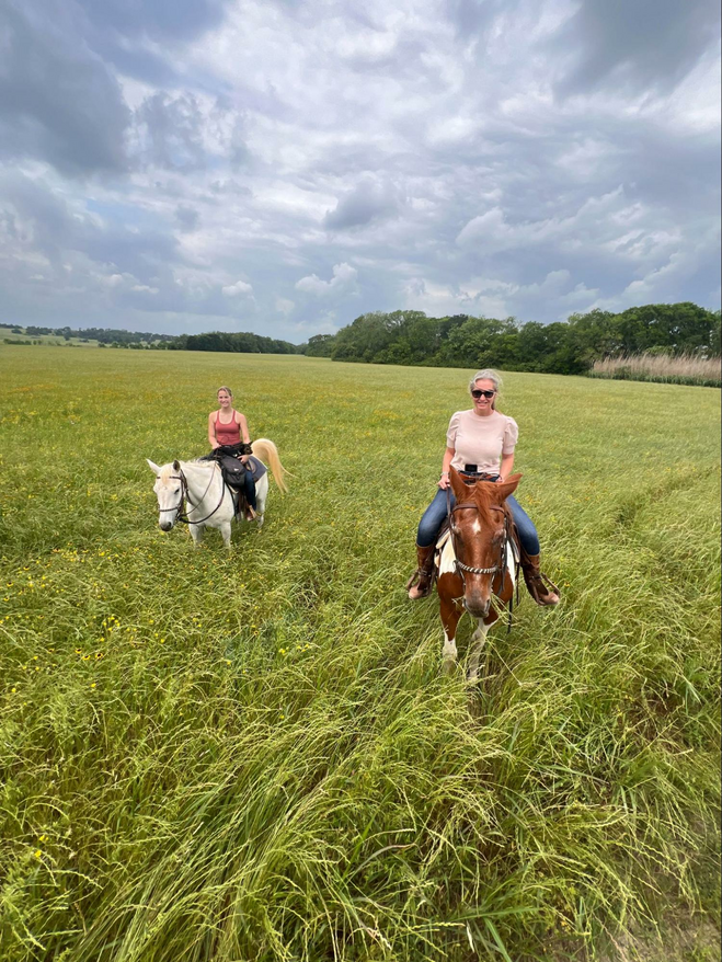 Two women on horseback in Brenham, Texas. 