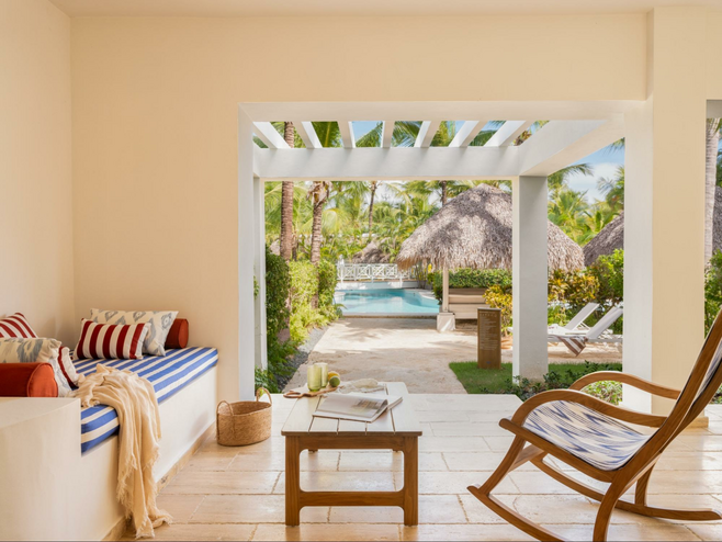 Resort ground floor room looking out towards pool and lush grounds