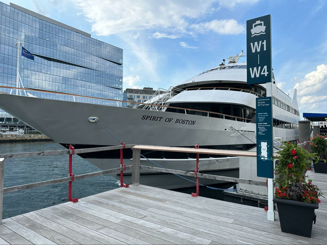 Image of the front and side of the Spirit of Boston docked in the Boston Harbor.
